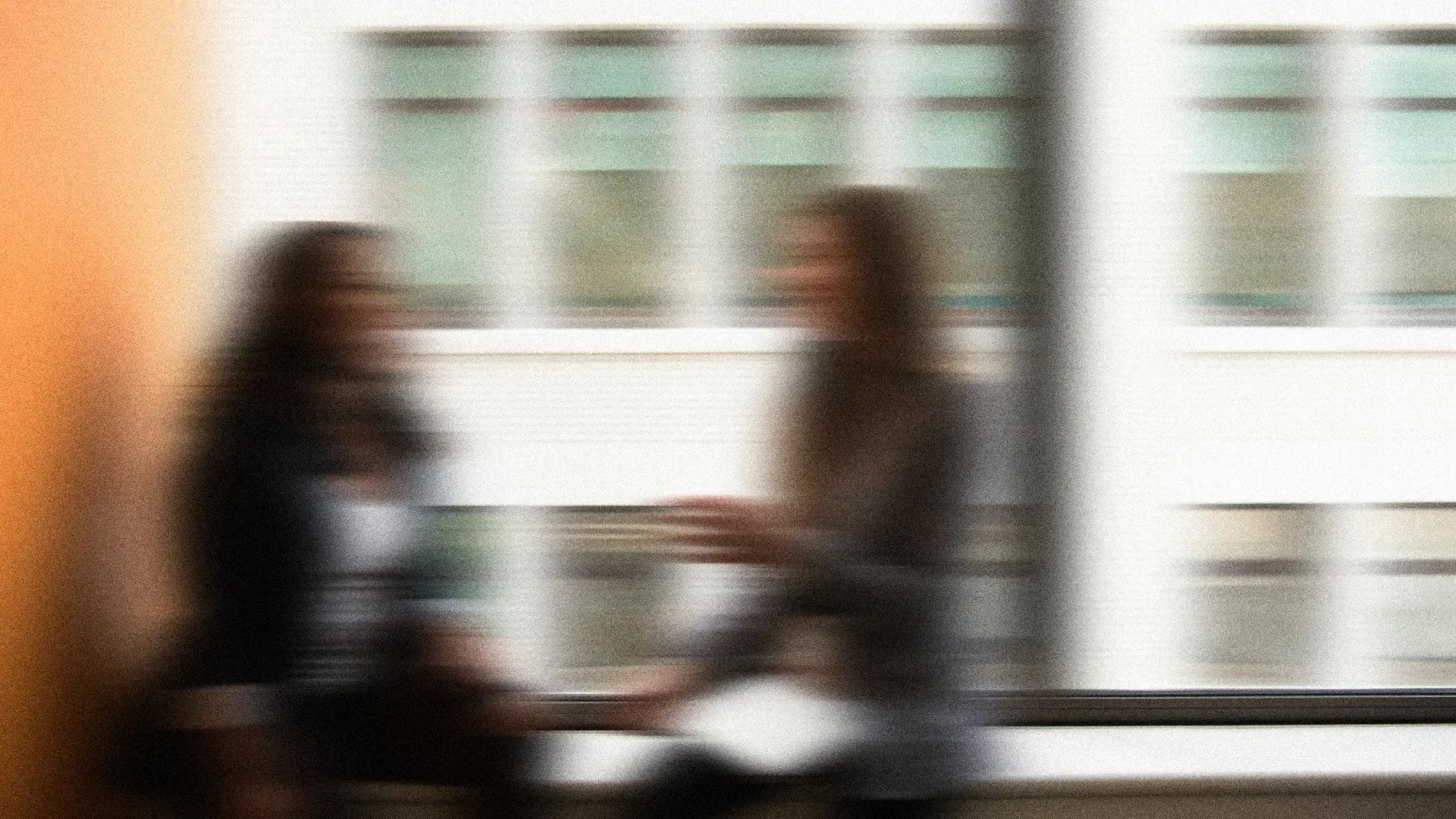 Two colleagues talking by an office window